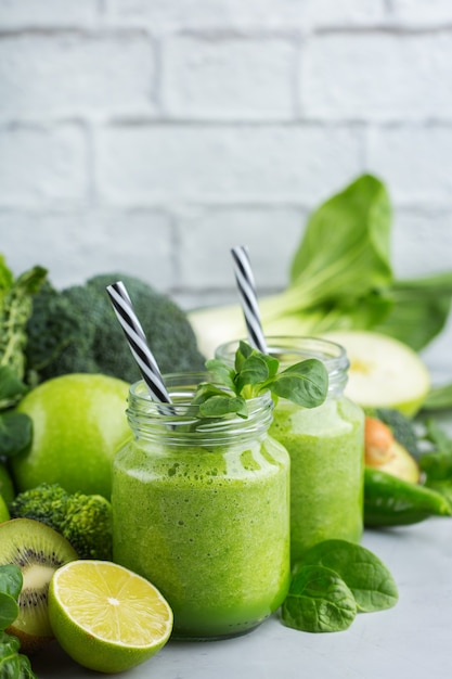 Food and drink, healthy dieting and nutrition, lifestyle, vegan, alkaline, vegetarian concept. Green smoothie with organic ingredients, vegetables on a modern kitchen table