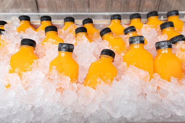 Food and drink orange juice in a bottle with ice