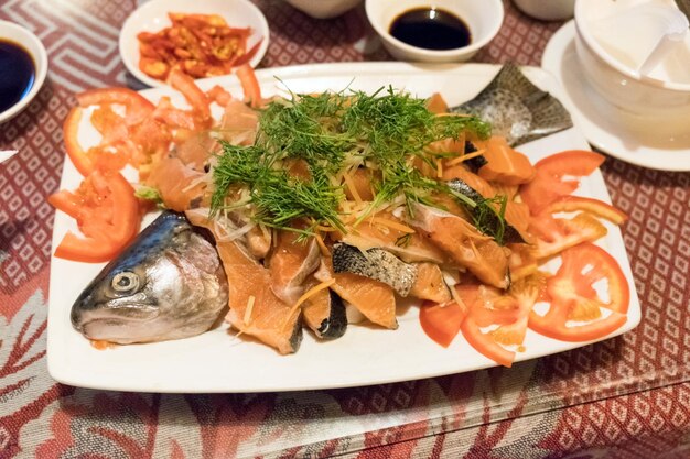 Food fresh Salmon sliced with vegetable and sauce on plate