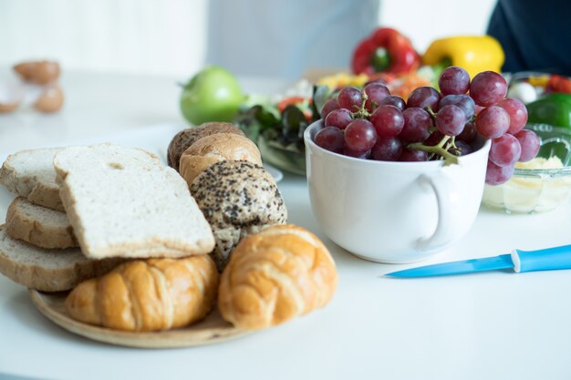 Photo food - fruits: bread, apple, canned, salads and blue knives.