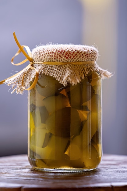 Food glass with papaya jam in syrup with fig close up