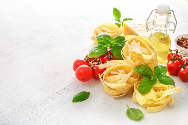 Food ingredients for italian pasta on white.