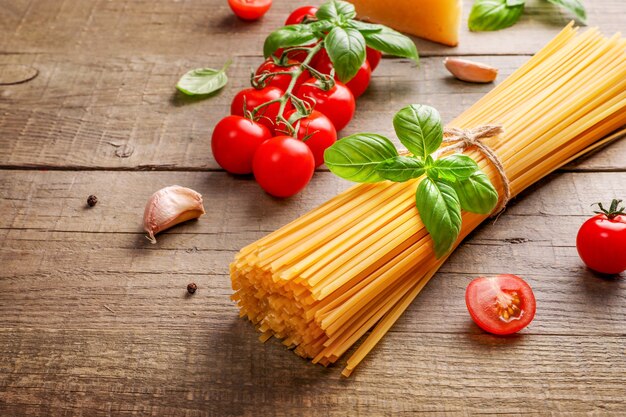 Food ingredients for italian pasta on wooden.