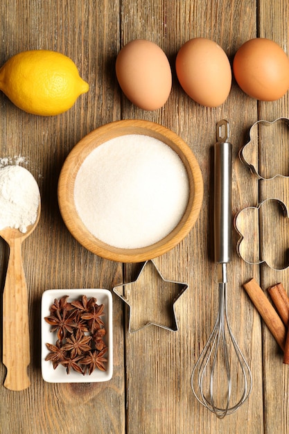 Food ingredients and kitchen utensils for cooking on wooden background