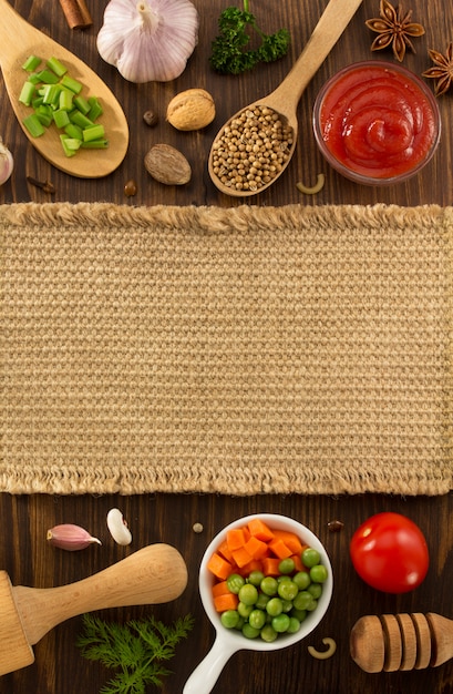 Food ingredients and spices on wooden background