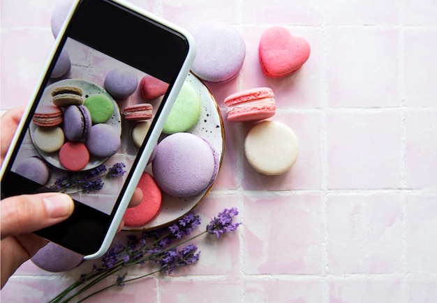 Food photography concept. Photo of French desserts macaroon with lavender taken on a smartphone