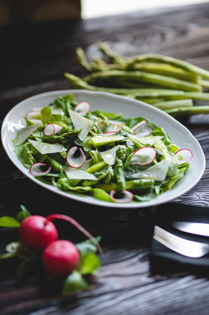 Food photography Green salad with fresh vegetables asparagus and radishes