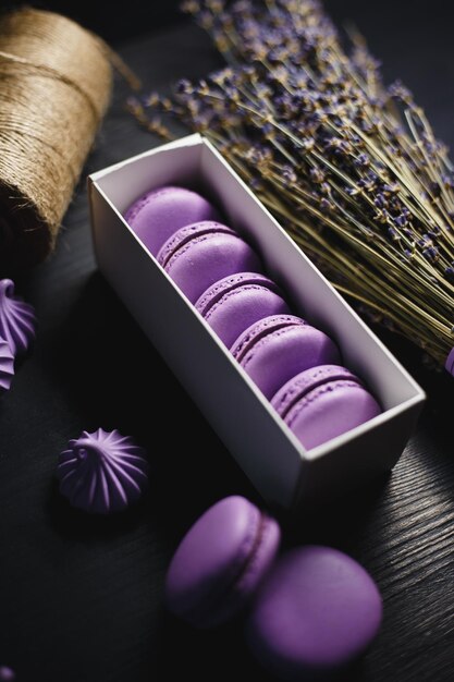 Food photography Macaroon purple with chocolate filling on a black wooden background
