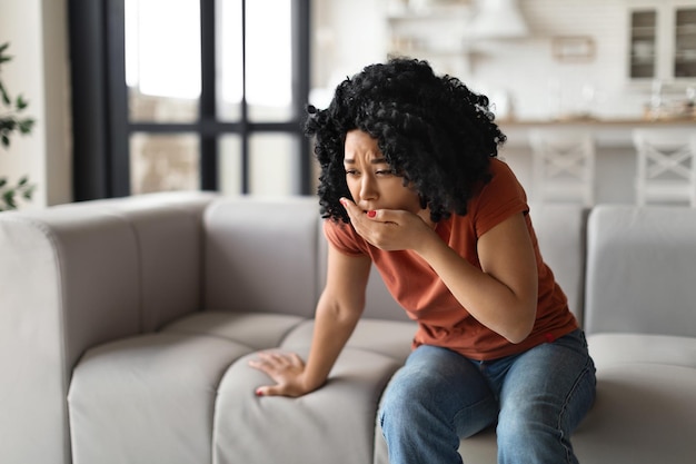 Food poisoning concept young black female feeling sick at home