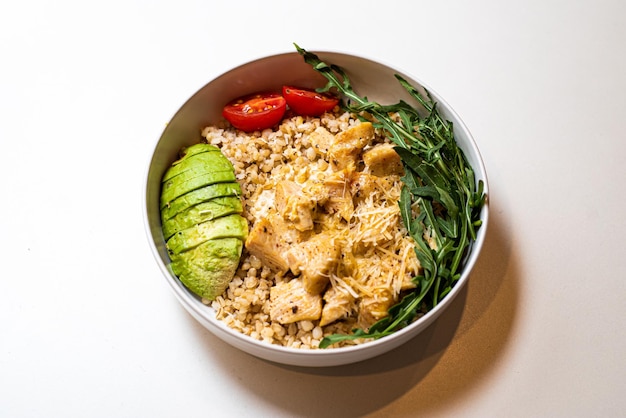 Food porridge with vegetables in a plate on a white background