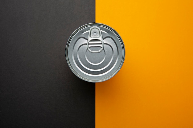 food preserve metal can on orange and brown background