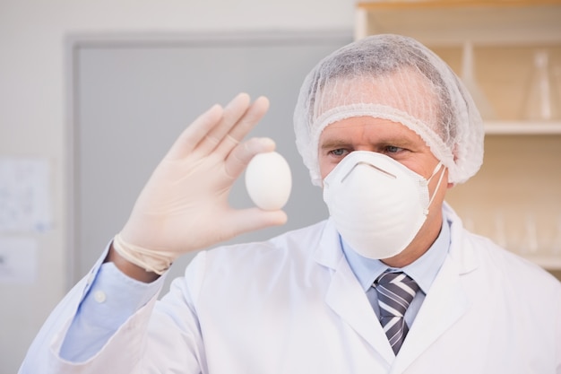 Food scientist holding an egg 