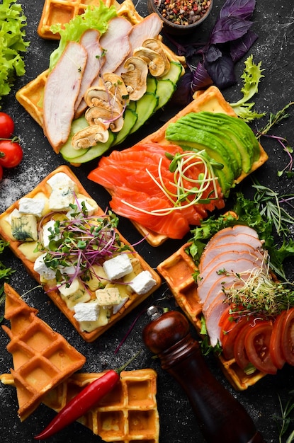 Food Set of Belgian waffles for breakfast On a black stone background Top view Free space for your text