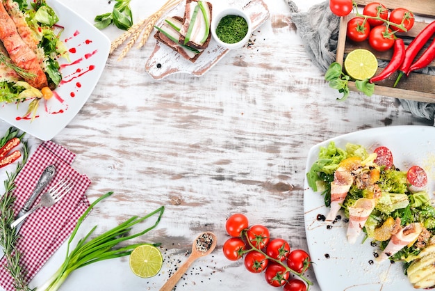 Food A set of delicious salad with avocado and vegetables On a wooden background Top view Copy space