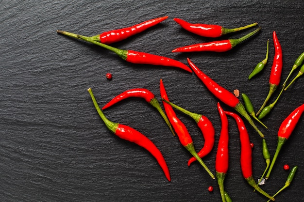 Food spicy presentation background red chili and green chili on black slate board