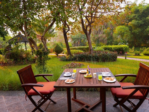 Food on table against trees in park