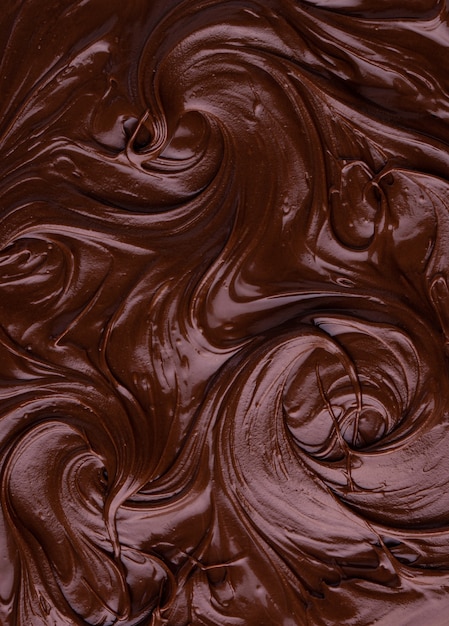 Фото Пищевая текстура растопленного шоколада или спреда