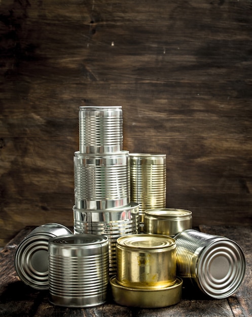 Food in tin cans on a wooden background