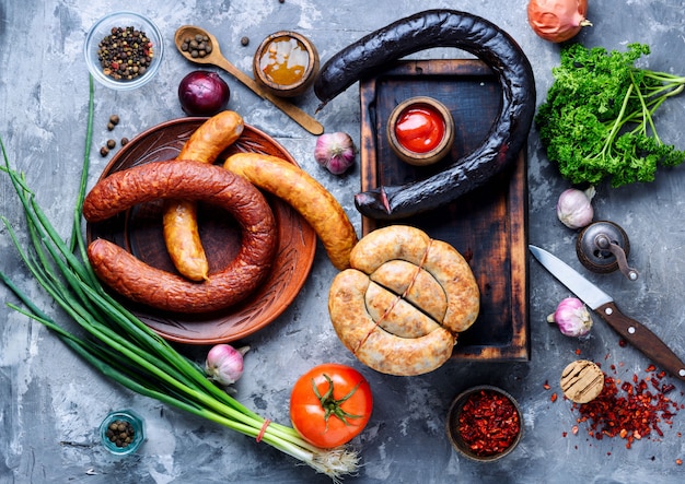 Food tray with delicious sausages and fresh salami.Meat platter