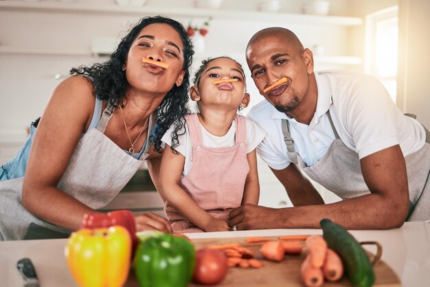 Photo food vegetables and portrait of girl with parents together for learning child development and bonding in kitchen family cooking and playful mom dad and funny kid prep for meal lunch or dinner