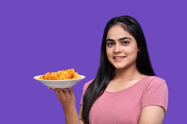 Foodie girl smiling and holding biryani indian pakistani model