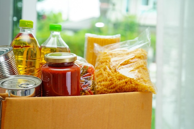 Photo foodstuffs in donation box for volunteer