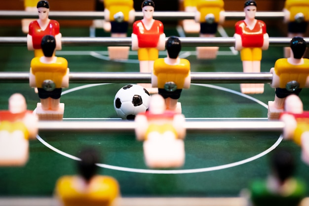 Foosball table soccer. football player, sport concept