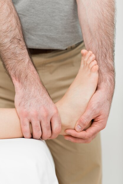 Foot being manipulated by a practitioner