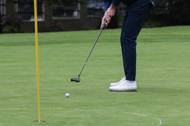 Foot of golfer with putting golf ball copy space