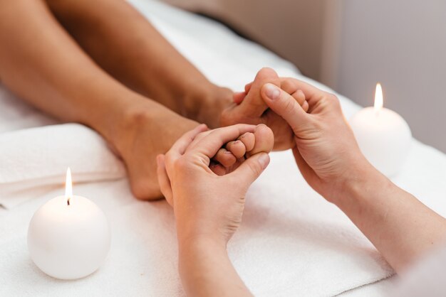 Foot massage in the spa salon in the garden