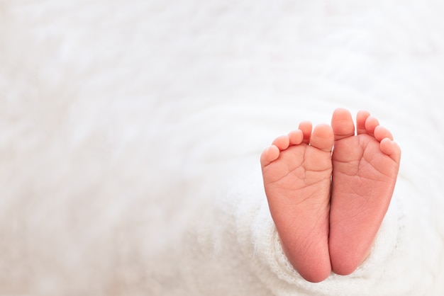 Foot of the newborn baby, tenderness. copyspace in winter 