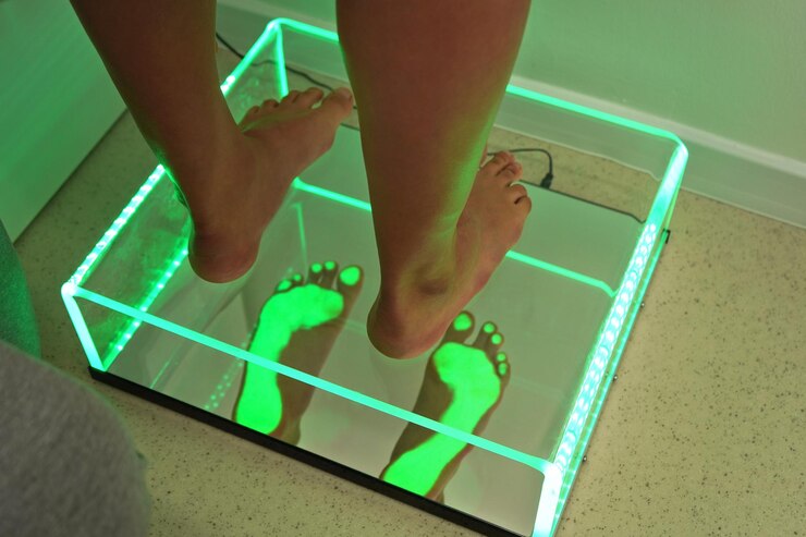 Photo foot step analysis on feet scanner - footprints visible in green light on plastic panel