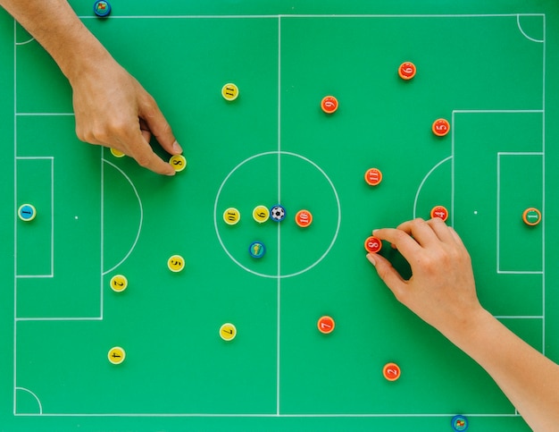 Football background with tactics concept and hands