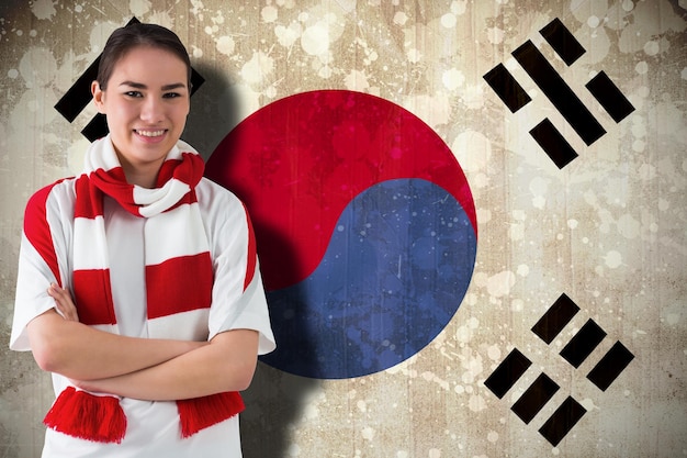 Фото Футбольный фанат в белом шарфе против флага южной кореи