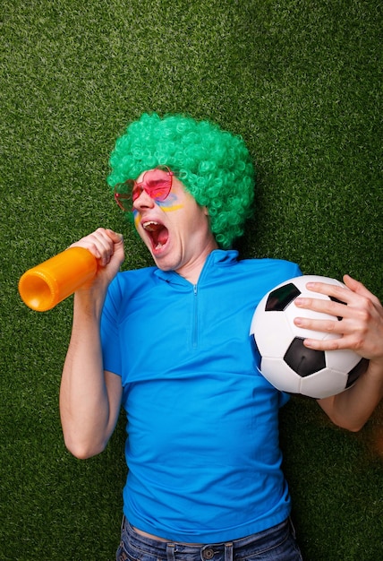 Football fan support his team and celebrate a goal