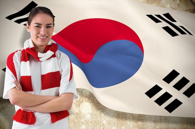 Футбольный болельщик в белом шарфе против флага корейской республики