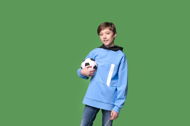 Football fans Smiling caucasian teen boy holding soccer ball in hands