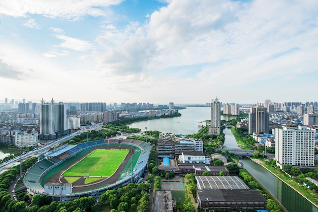 Football field in Big city - Bangkok, Thailand with beautiful sky. Bangkok city with sunset.