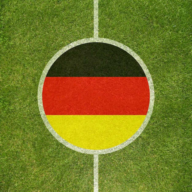 Крупный план центра футбольного поля с немецким флагом в кругу