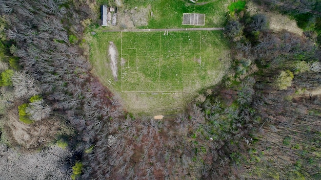 Football field in the forest shooting from a drone