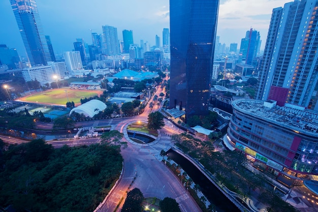 Football field with skyscraper at dusk time