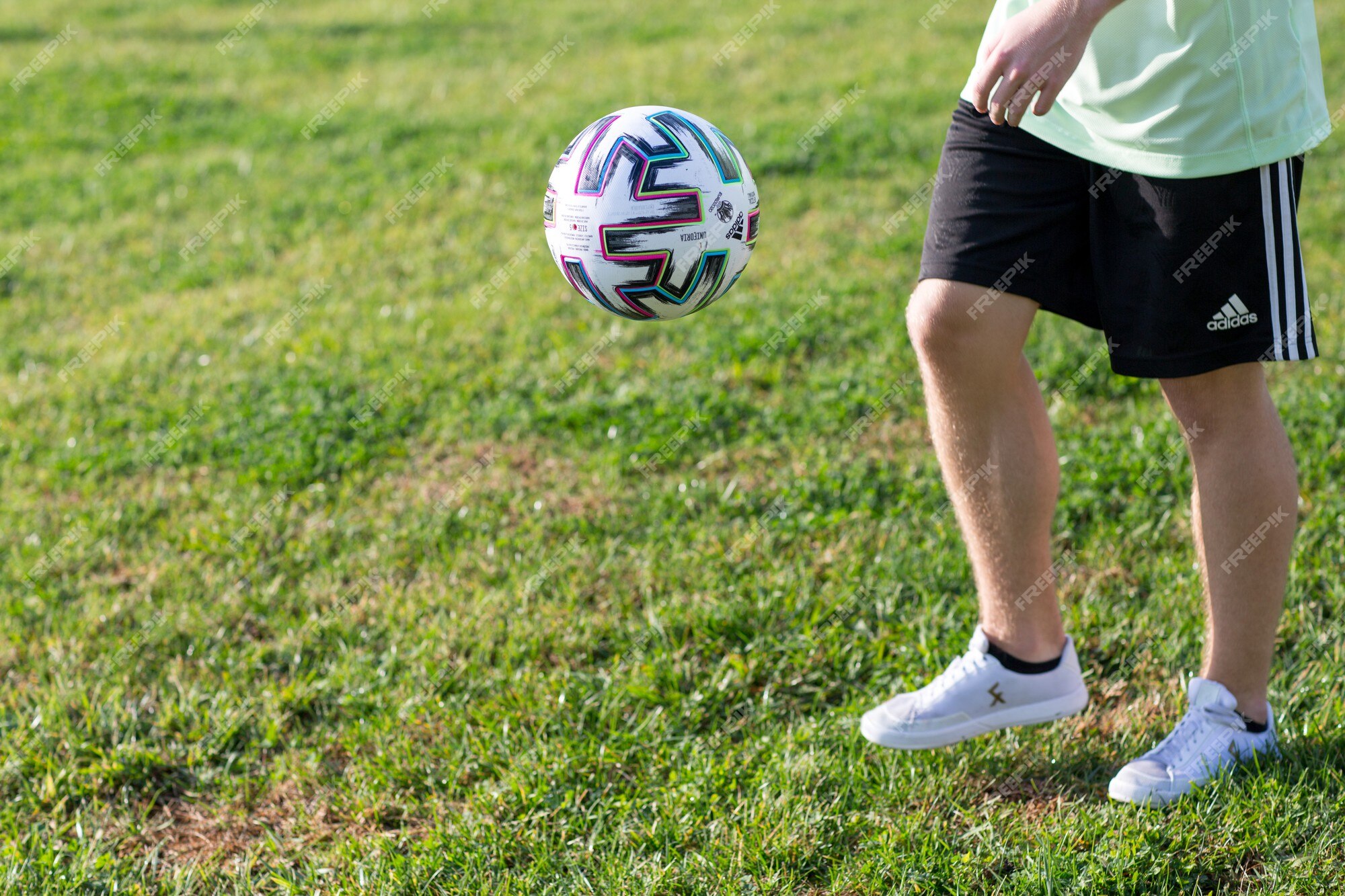 Premium Photo Football freestyle. young man practices with soccer ball. player training the basic tricks with the ball.