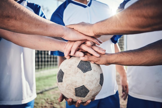 Football hands together and collaboration for support sports and training at stadium Teamwork group huddle and soccer players with motivation for exercise workout goal and success in competition