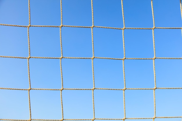 Football net on blue sky background