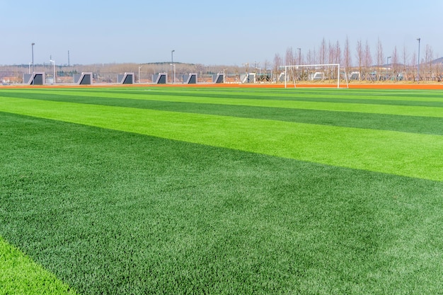 Football pitch and a cloudy sky. Green field.