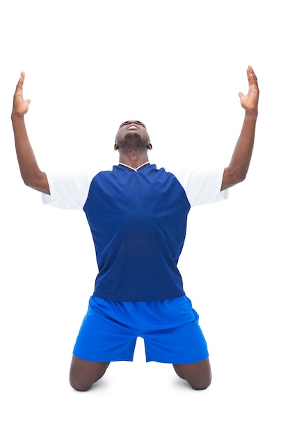 Football player in blue celebrating a win