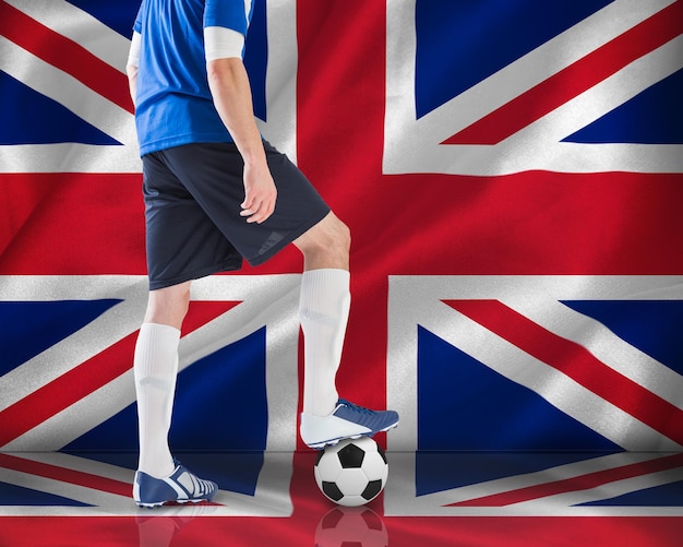 Photo football player in blue jersey against digitally generated uk national flag