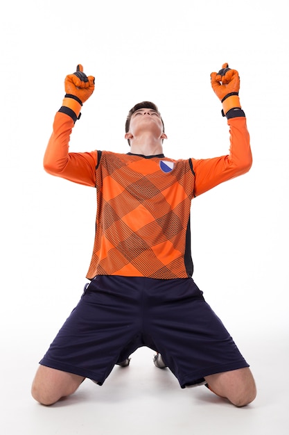 Football player celebrating a goal isolated in white