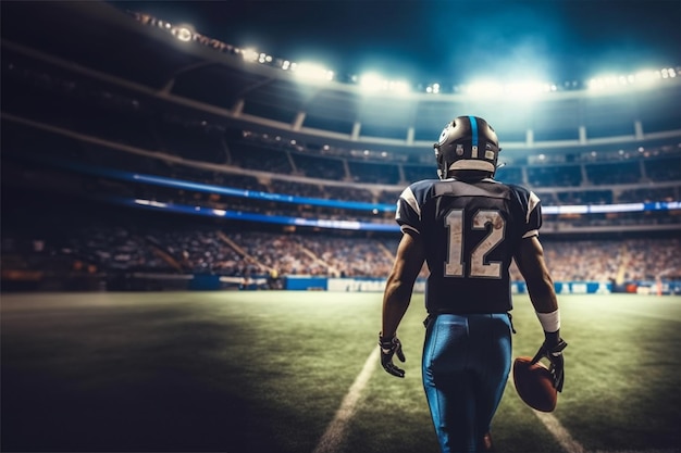 a football player from behind holding football on his hand ready to play