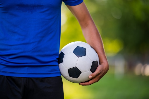 Football player holding a football ball